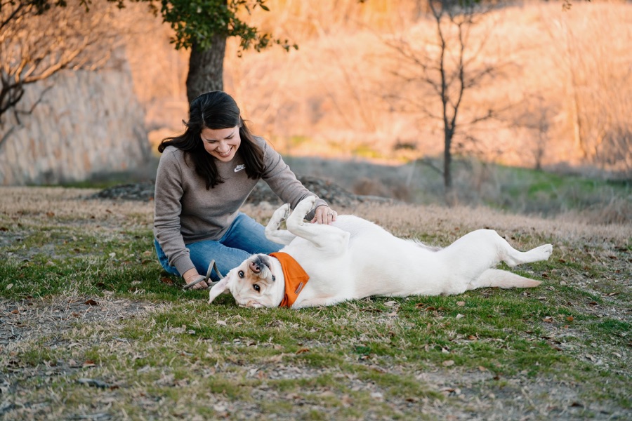 Sara sharing some playtime with a yellow Labrador